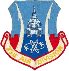 33d Air Division
Although this patch displays "33d AIR DIVISION" on its scroll, the emblem on the shield is for the Washington Air Defense Sector.  When the sector was replaced in 1966 by the 33d Air Division, either someone incorrectly believed the WADS emblem would continue to be used and therefore ordered a batch of the pictured patch, or an unsuccessful attempt was made to make the WADS emblem the new official emblem of the 33 AD.  Either way, this is a patch that was never approved, but was worn for a short time. -GWO

