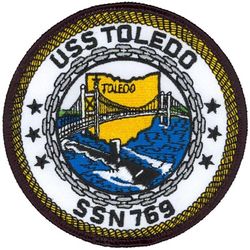 SSN-769 USS Toledo 
Namesake. The City of Toledo, OH
Awarded. 10 Jun 1988
Builder.	Newport News Shipbuilding and Drydock Company
Laid down. 6 May 1991
Launched. 28 Aug 1993
Sponsored by. Mrs. Sabra Smith
Commissioned. 24 Feb 1995
Motto. "Forged from Metal, Prepared for Battle"
Class and type. Los Angeles-class submarine
Displacement:	
6,000 long tons. (6,096 t) light
6,927 long tons. (7,038 t) full
927 long tons. (942 t) dead
Length. 110.3 m (361 ft 11 in)
Beam. 10 m (32 ft 10 in)
Draft. 9.4 m (30 ft 10 in)
Propulsion:	
1 × S6G PWR nuclear reactor with D2W core (165 MW), HEU 93.5%
2 × steam turbines (33,500) shp
1 × shaft
1 × secondary propulsion motor 325 hp (242 kW)
Complement	12 officers, 98 men
Armament:	
4 × 21 in (533 mm) torpedo tubes
12 × vertical launch Tomahawk missiles

