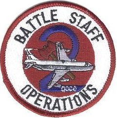 2d Airborne Command and Control Squadron Battlestaff Operations
2 ACCS/DOCO Functional patch worn on the left shoulder by the Director of Battlestaff Operations (called the "DOCO"--long o's) and the two enlisted team members supporting the DOCO (Emergency Actions Controller and Force Status Controller). The design puns on the unit designation, having a large "2" superimposed over an axe (with the office symbol appearing on the base of the "2"). It was worn from the late 1980s until 1993. 
