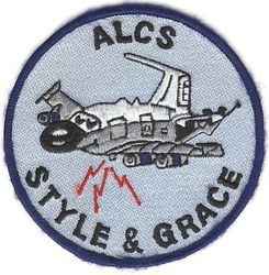 4th Airborne Command and Control Squadron Airborne Launch Control System
Morale patch created in mid-to-late 1980s, probably by Paul Weiser,* and worn by Airborne Launch Control System members. The story goes that the squadron commander at the time was incessantly harping on the importance of always exhibiting style and grace in all endeavors, and this patch was made so that no ALCS member wearing it could ever be accused of not displaying "style and grace."

 *Paul Weisner drew a similar design (aircraft caricature) for a print that was given to departing members, so if he didn't design the patch, it was certainly based on his art. 
